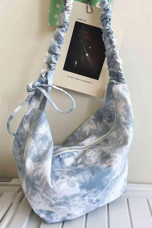 a blue and white bag hanging on a wall