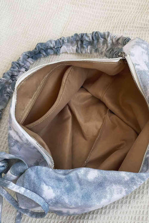 a handbag with a blue and white tie dye design