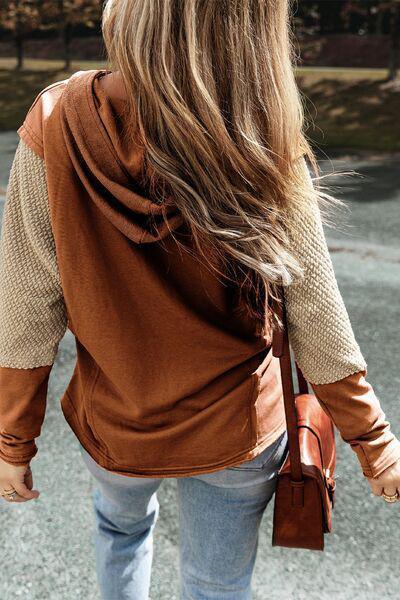 a woman with long hair walking down a street