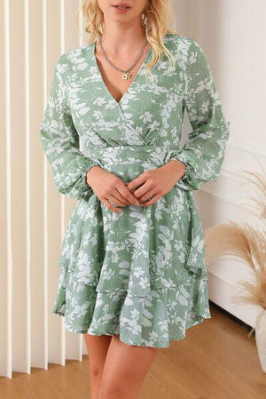 a woman in a green dress posing for a picture