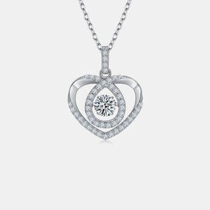 a heart shaped pendant with a diamond in the center