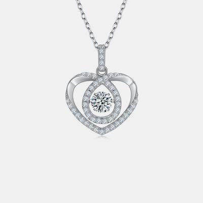a heart shaped pendant with a diamond in the center