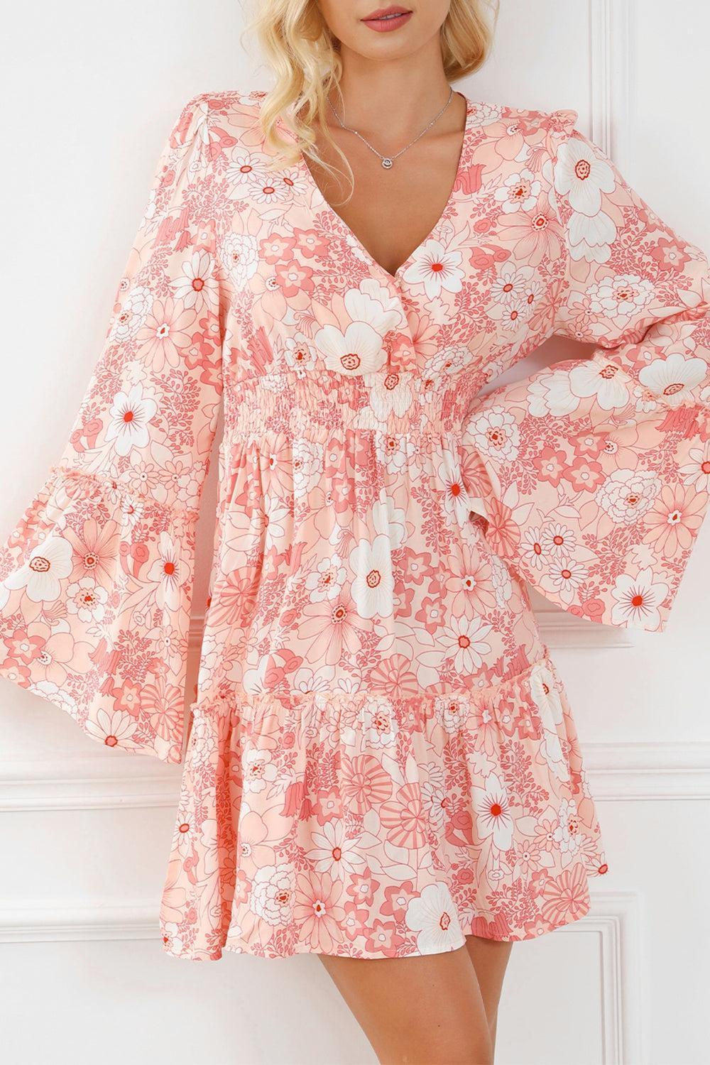 a woman wearing a pink floral print dress