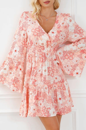 a woman wearing a pink floral print dress