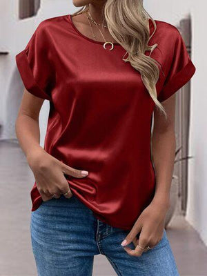 a woman wearing a red top and jeans