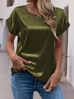 a woman wearing a green top and jeans