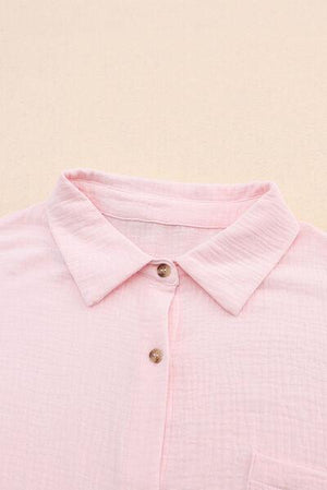 a close up of a pink shirt with buttons