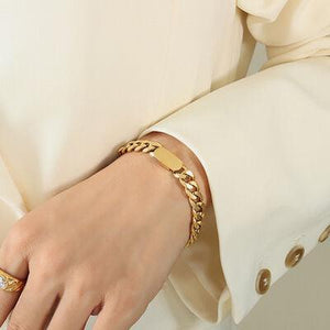 a close up of a person wearing a gold bracelet