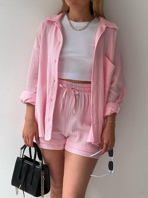 a woman wearing pink shorts and a pink jacket