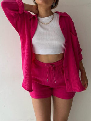 a woman wearing pink shorts and a white top