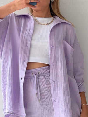 a woman in a white top and purple pants