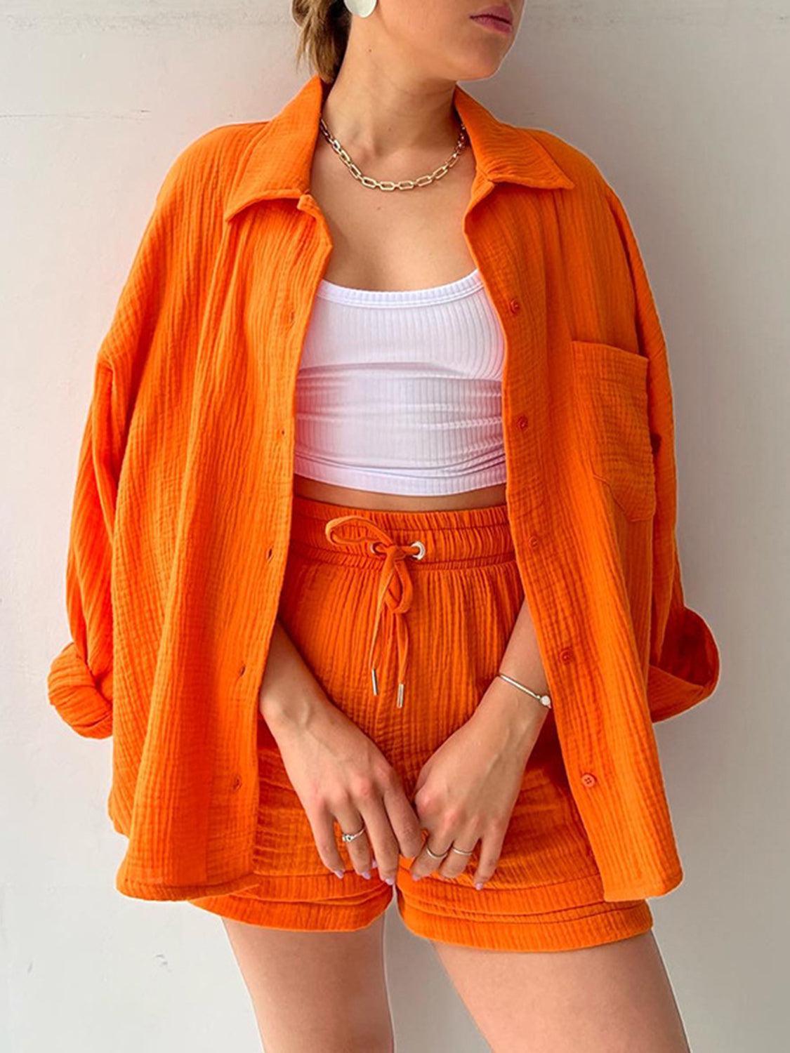 a woman wearing an orange jacket and shorts