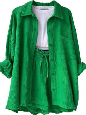 a green shirt with a white shirt underneath it