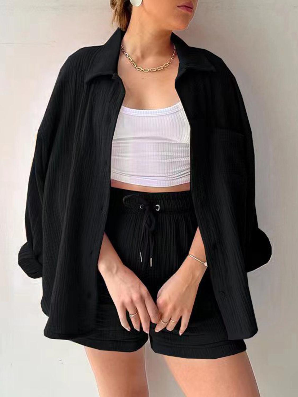 a woman wearing a white top and black shorts