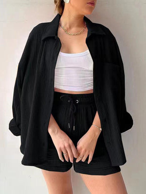 a woman wearing a white top and black shorts