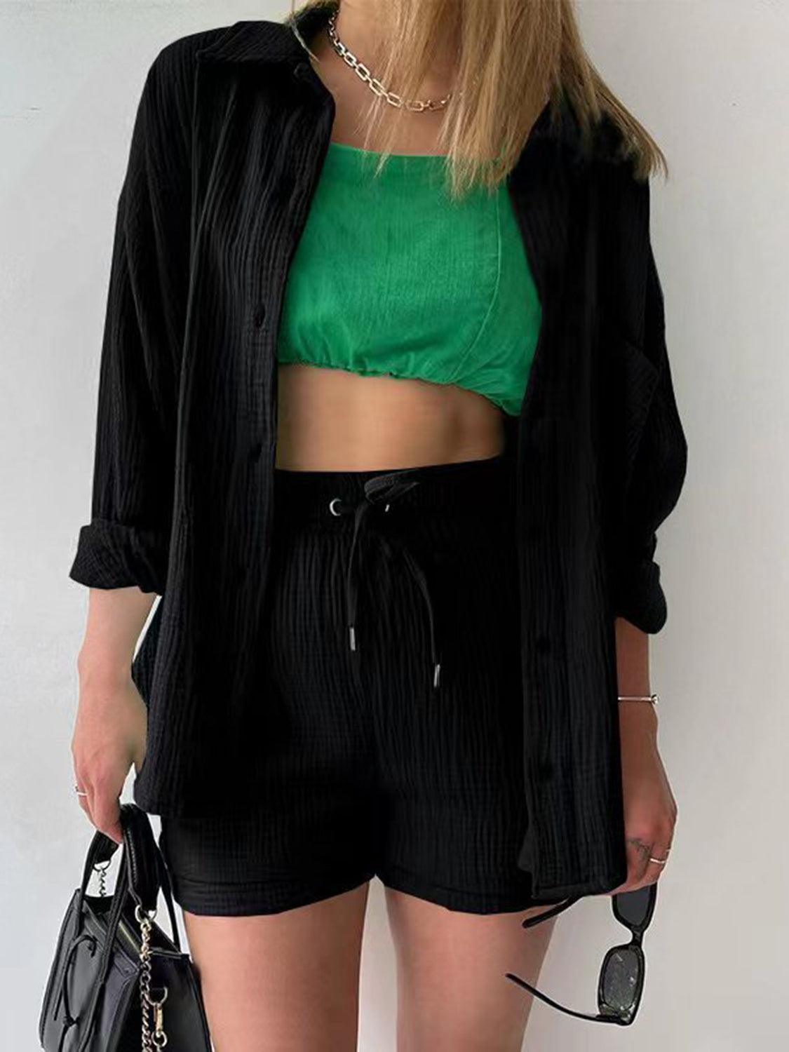 a woman wearing a green crop top and black shorts