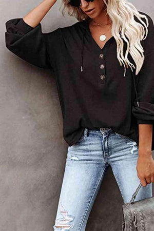 a woman wearing ripped jeans and a black top