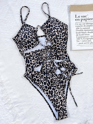 a leopard print bathing suit next to a book