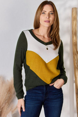 a woman standing in front of a white wall
