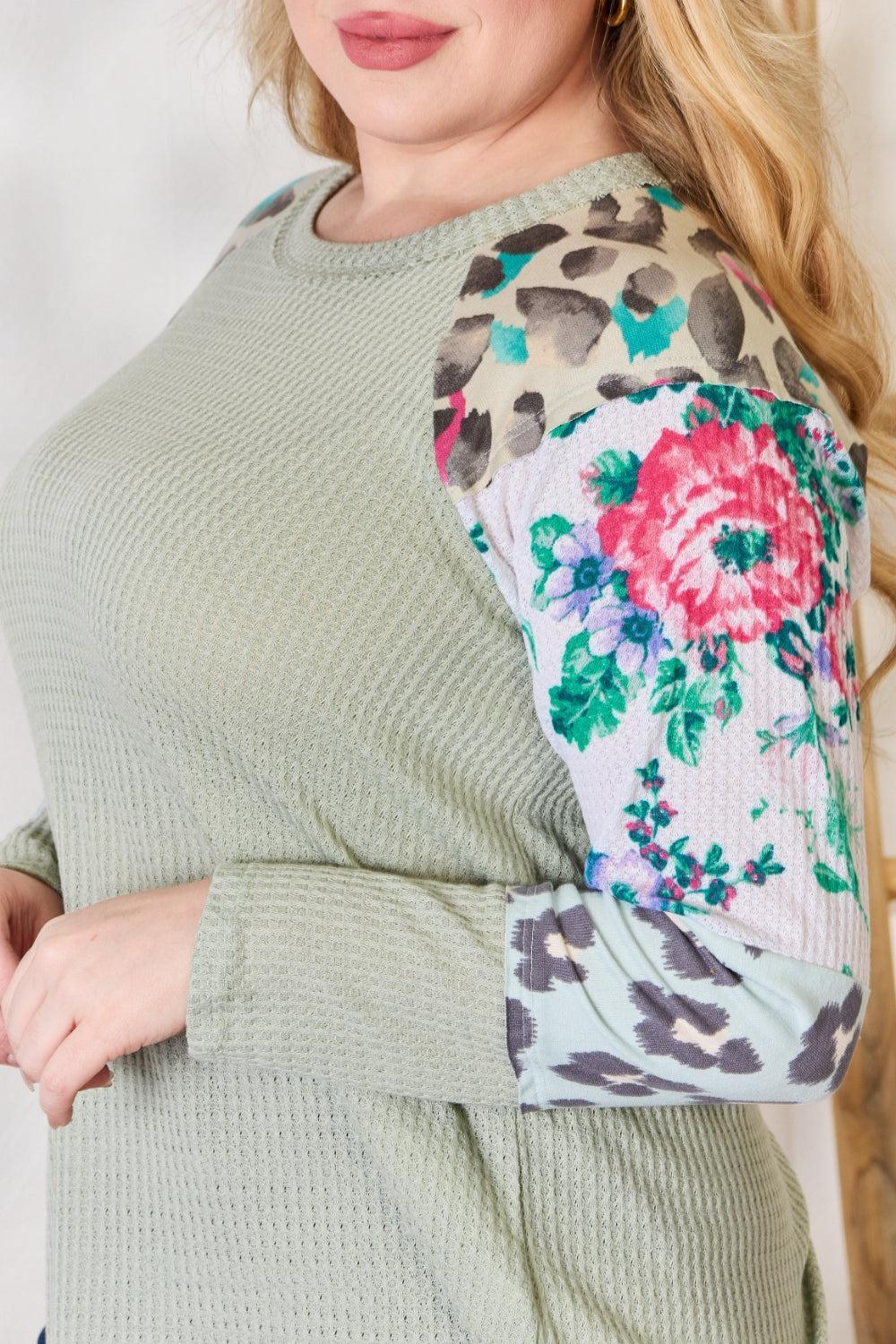 a woman with blonde hair wearing a green sweater