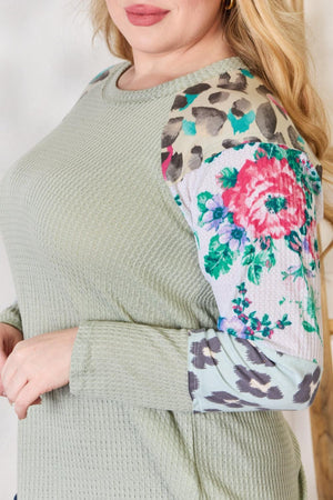 a woman with blonde hair wearing a green sweater