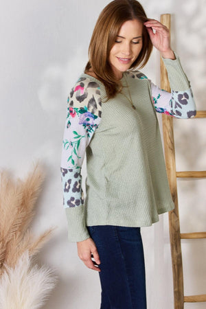 a woman standing next to a wooden ladder