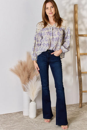 a woman standing in front of a white wall