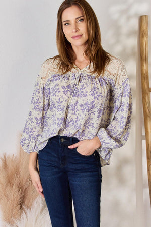 a woman standing in front of a white wall
