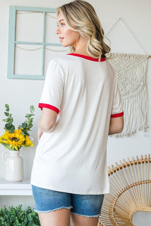 a woman wearing a white shirt and denim shorts