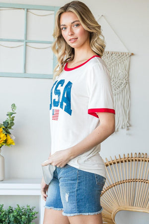 a woman in shorts and a t - shirt posing for a picture