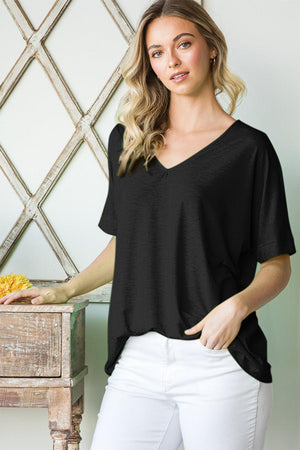 a woman standing next to a wooden table