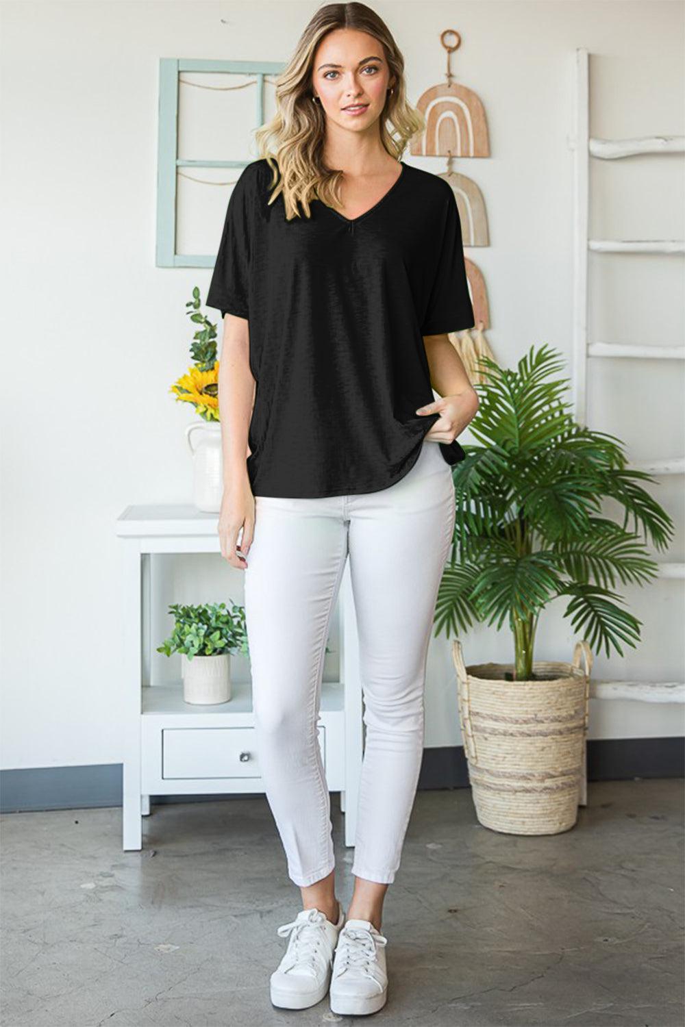 a woman standing in front of a plant