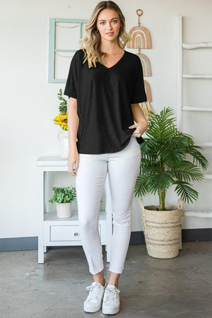 a woman standing in front of a plant