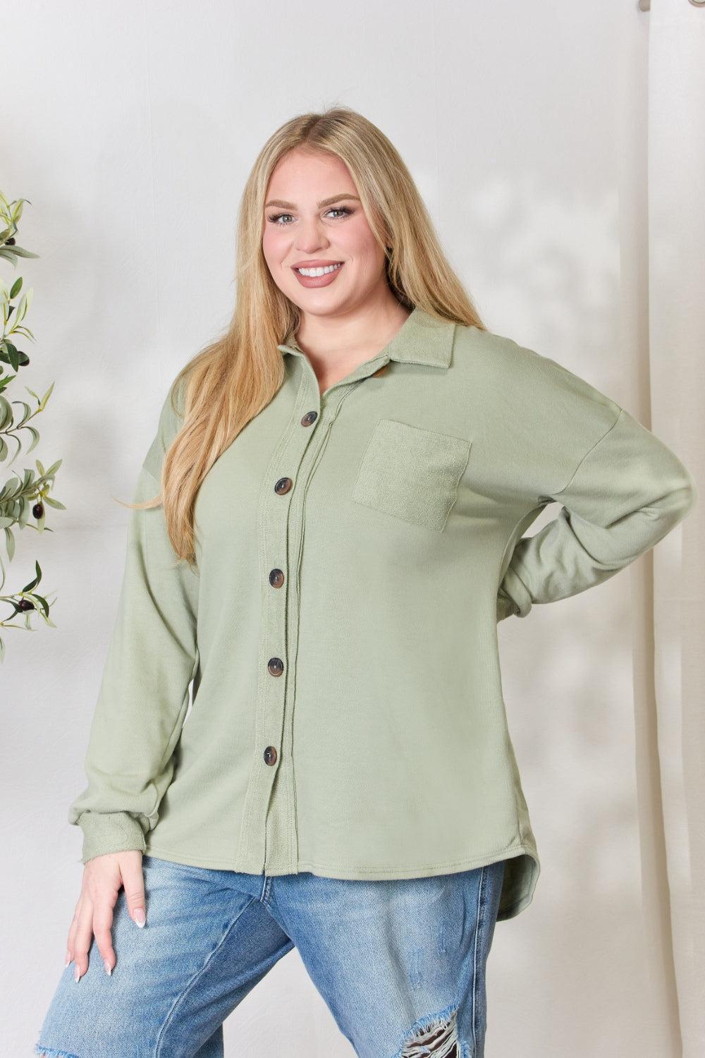 a woman wearing a green shirt and ripped jeans