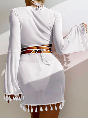 a woman in a white dress with a brown belt
