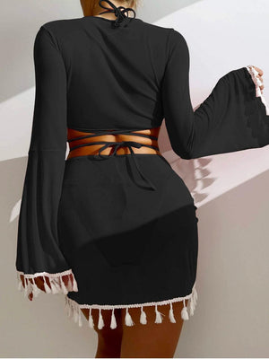 a woman wearing a black dress with a cut out back