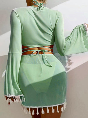 a woman in a green dress is standing