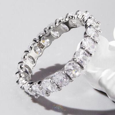 a diamond ring sitting on top of a white flower