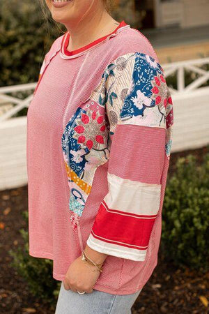 a woman standing in front of a white fence