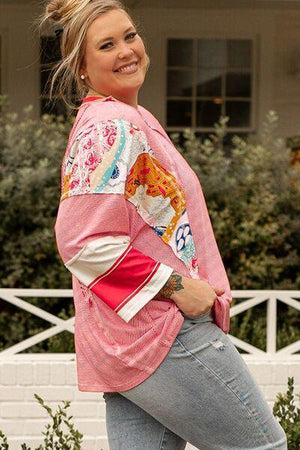 a woman in jeans and a pink shirt is smiling