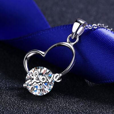 a necklace with a heart shaped diamond on it