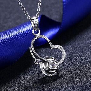 a heart shaped diamond pendant on a chain