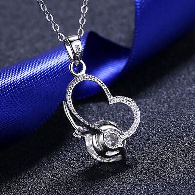 a heart shaped diamond pendant on a chain