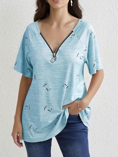 a woman wearing a blue top with birds on it