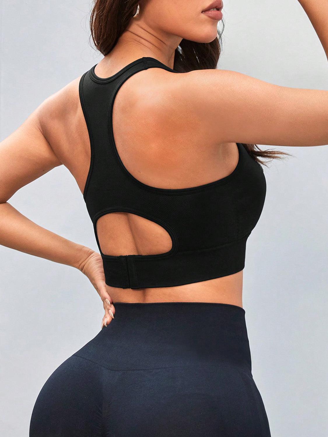 a woman wearing a black sports bra top and black leggings