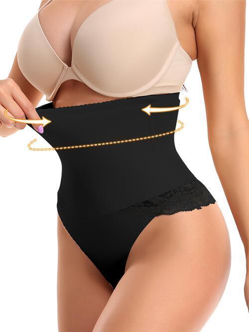 a woman wearing a black panties and a beige bra