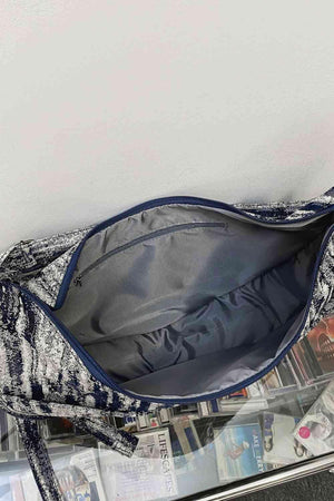 a blue and white purse sitting on top of a table