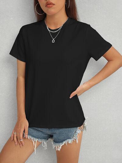 a woman wearing a black shirt and denim shorts