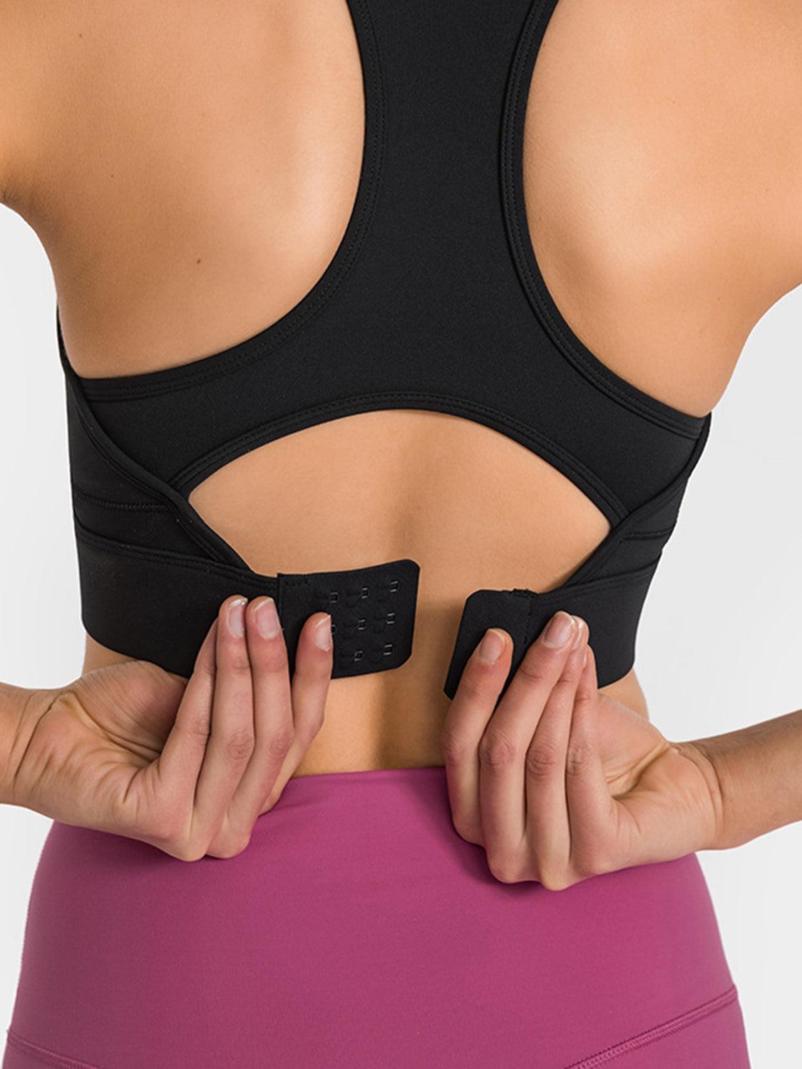 a woman wearing a black sports bra with her hands on her hip