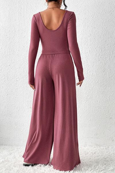 a woman in a pink jumpsuit with a backless top